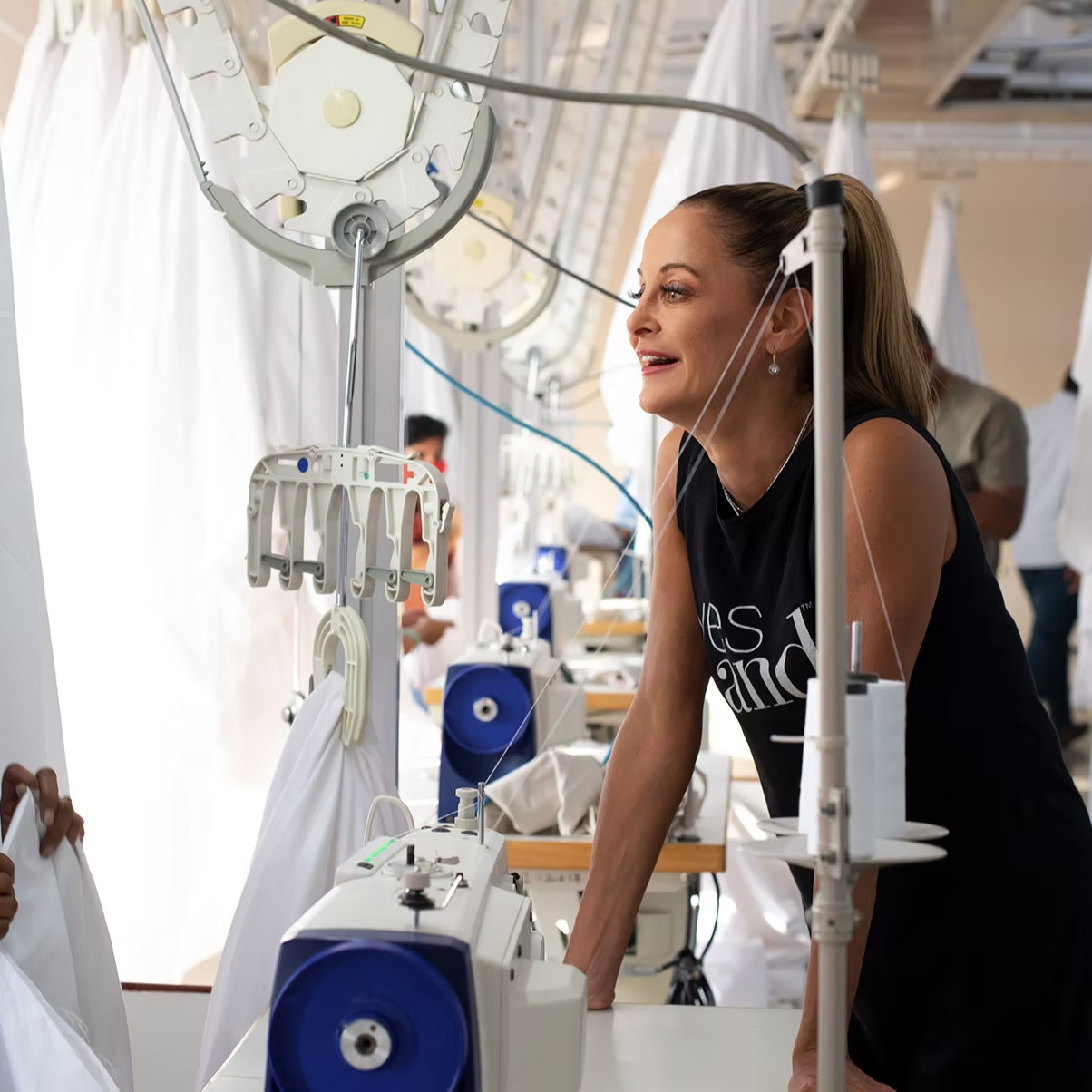 Inside a working garment floor — sewing lines running sustainable private-label production.